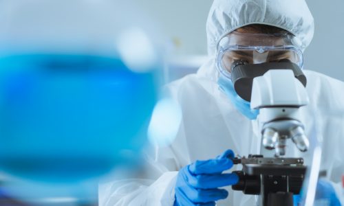 Young Asian handsome man scientist adjust focus and use Microscope to looking biochemical cell in laboratory. Doctor and scientist work in laboratory pandemic of corona virus, COVID19 concept Young Asian handsome man scientist adjust focus and use Microscope to looking biochemical cell in laboratory. Doctor and scientist work in laboratory pandemic of corona virus, COVID19 concept